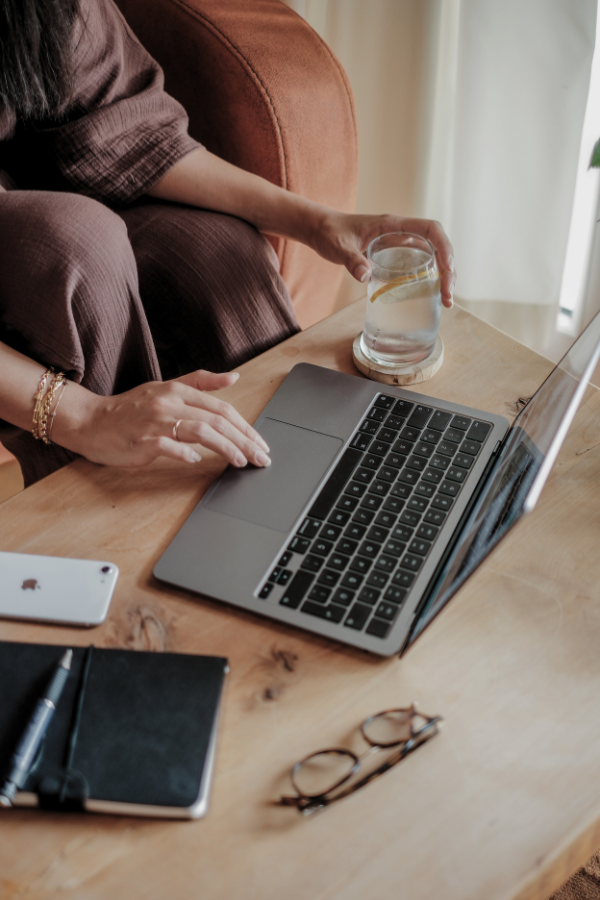 a woman types on her laptop