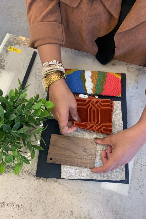 a designer arranges material samples