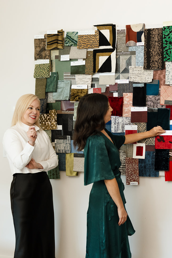 Laura and Megan pin samples to a mood board