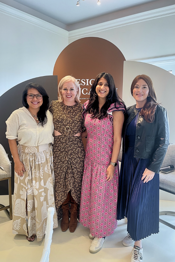four designers on a panel stand in front of a display at High point Market