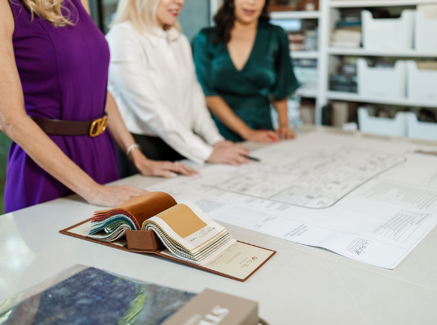 Three interior designers viewing floorplans