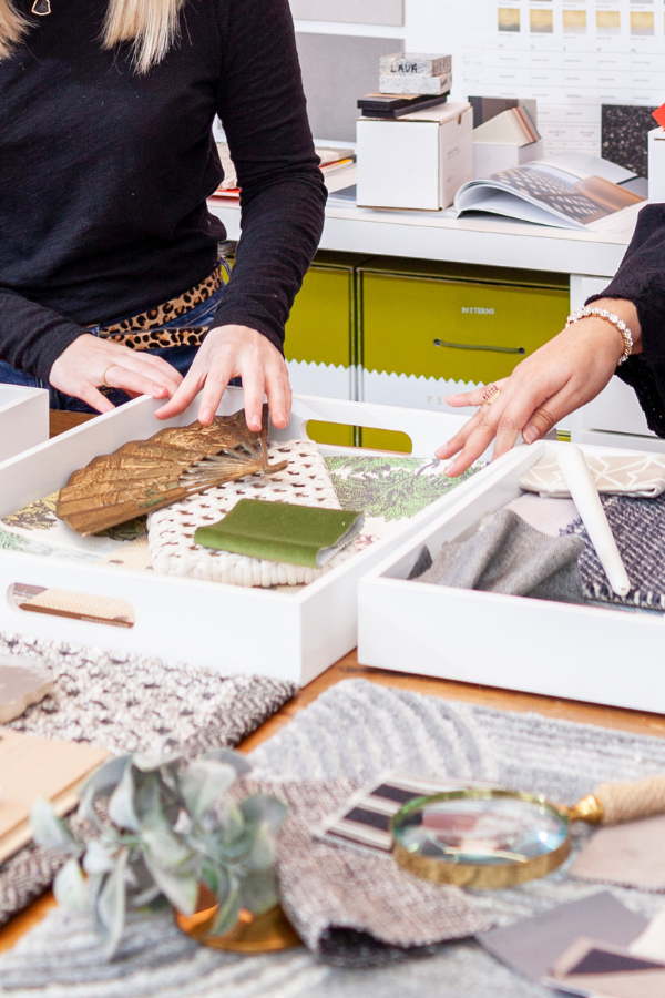 two women handling design samples