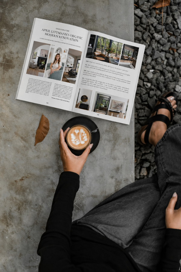 a woman reading designdash magazine