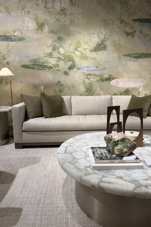 Bernhardt living room featuring a neutral sofa, round stone coffee table, and large botanical-inspired mural.