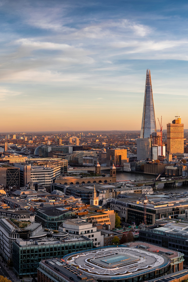 The Shard rising above central London with surrounding architecture and the River Thames below.