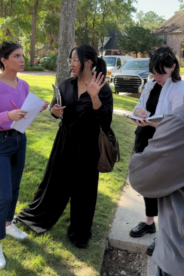 designers meet in a client's yard to discuss interior design work