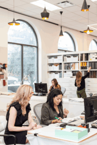 designers gather around desks in an interior design studio