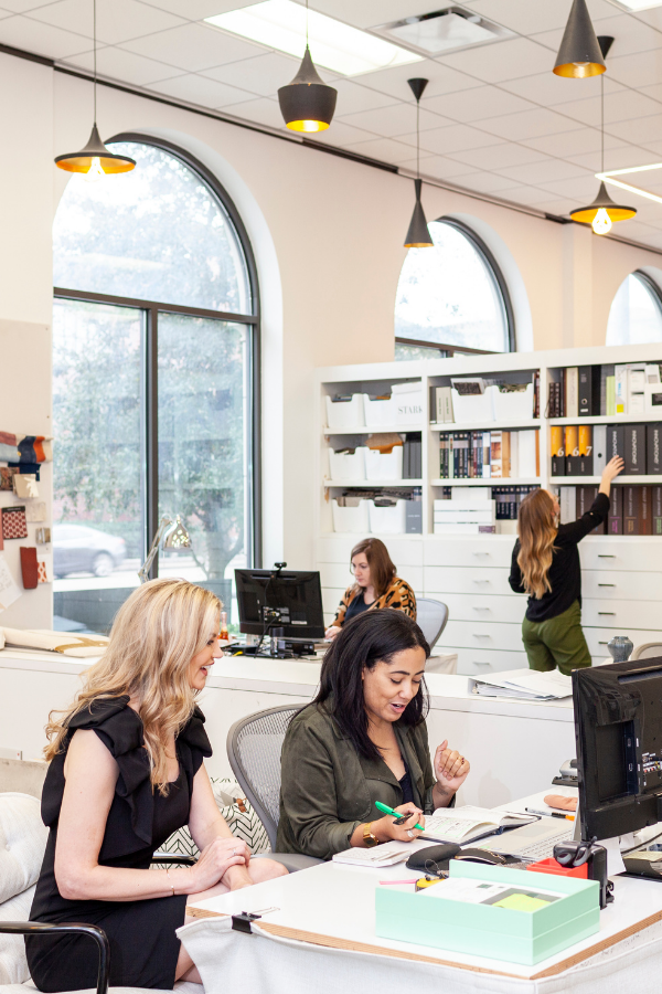 designers gather around desks in an interior design studio
